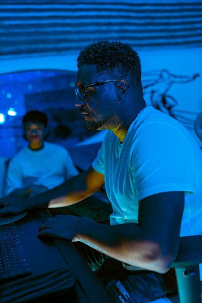 Keyz Bridgez at the mixing desk in a blue-lit studio