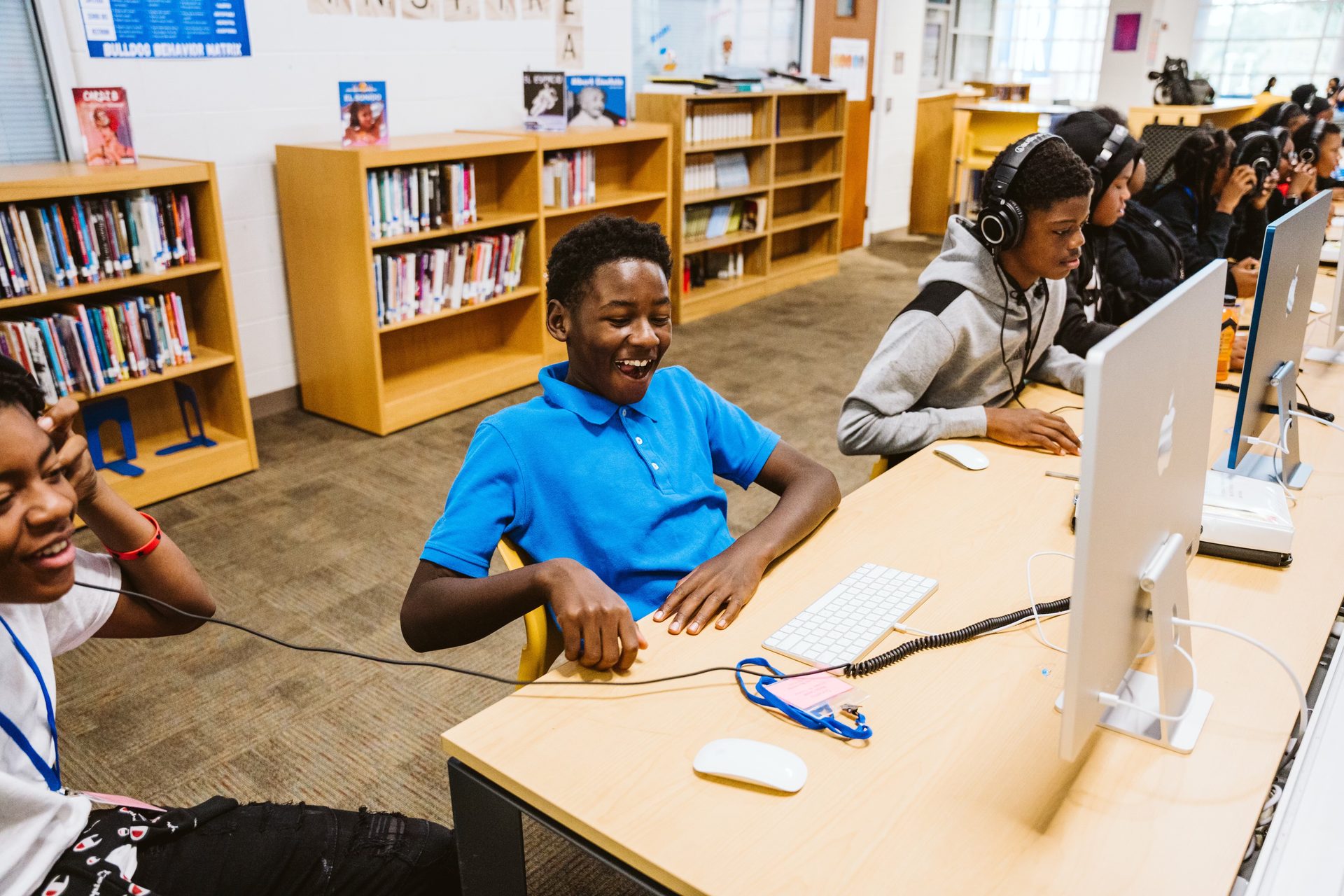 Students making music on computers in the library