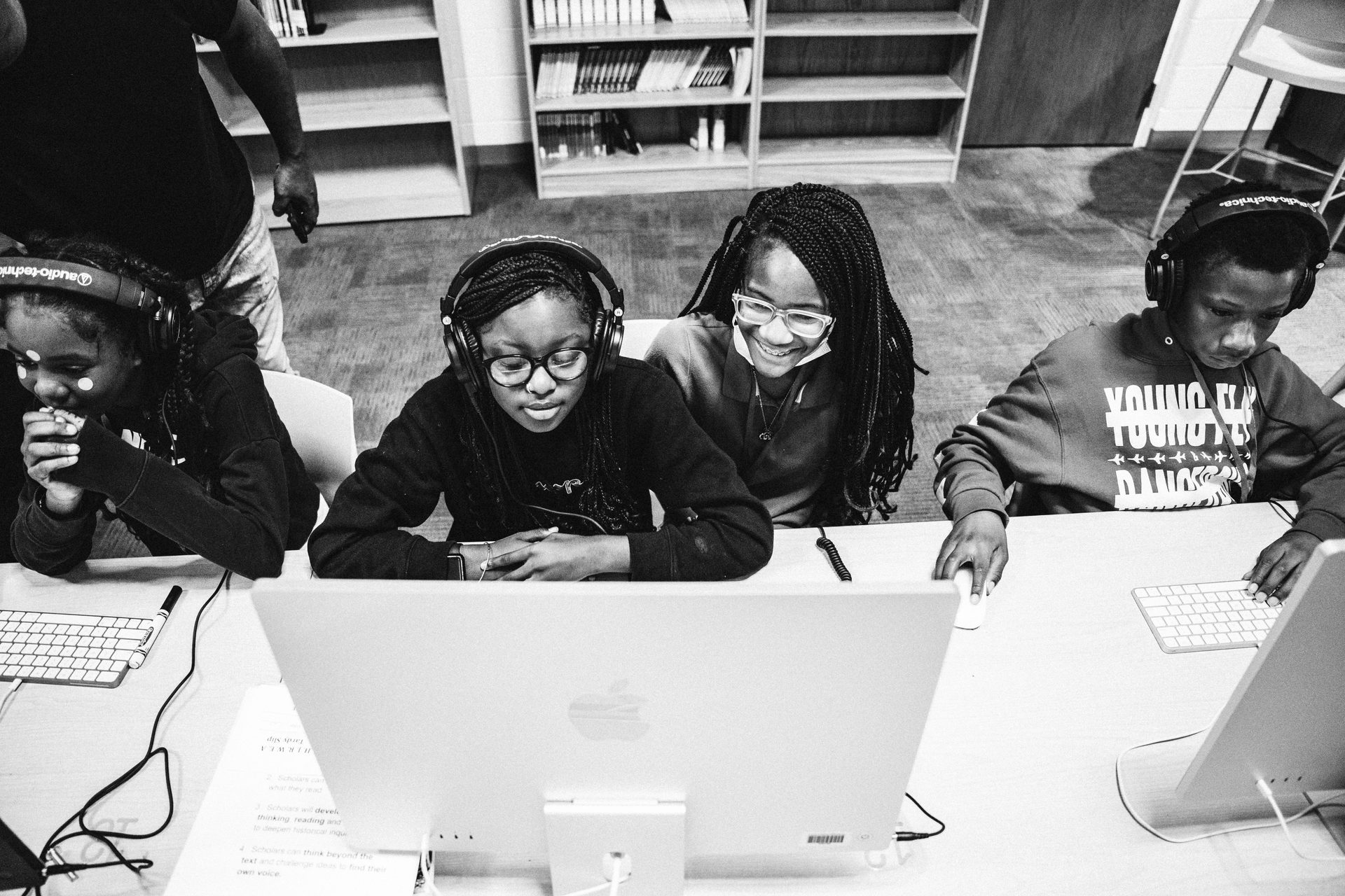 Students with headphones at their workstations